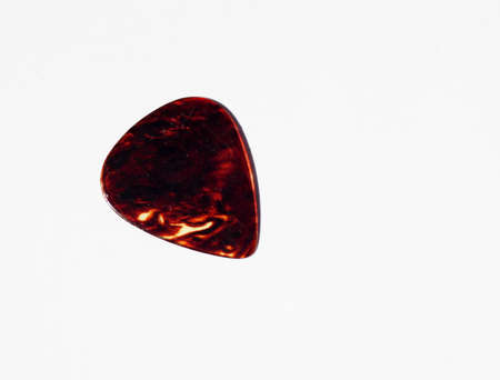 guitar pick against white backgroundの写真素材