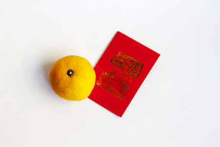 chinese red lucky money envelope and mandarin orange against white backgroundの写真素材