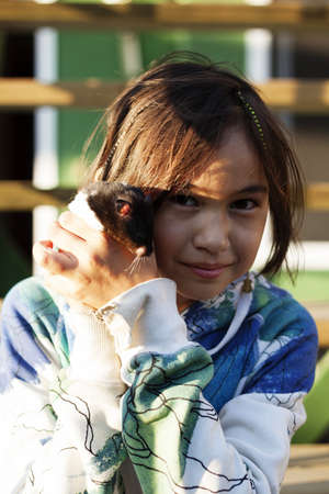 girl with hamster at sunsetの写真素材