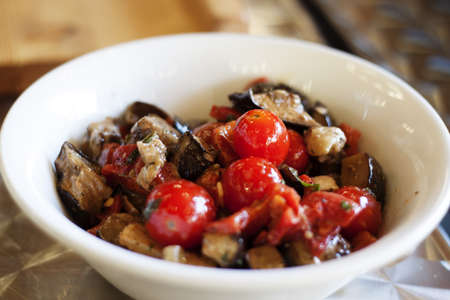 eggplant and tomato salad at trendy eateryの写真素材