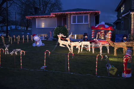 reindeer and sleigh in candy cane fenced lawnのeditorial素材