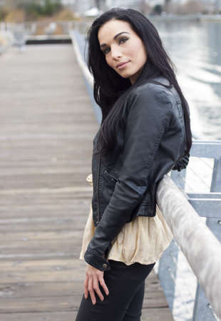 a woman standing at dockside smilingの写真素材