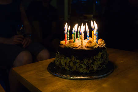 a birthday cake in dark roomの写真素材