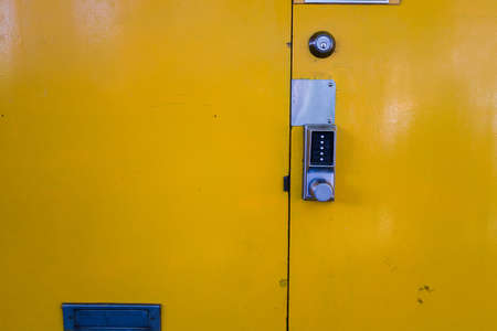 an old yellow metal doorの写真素材