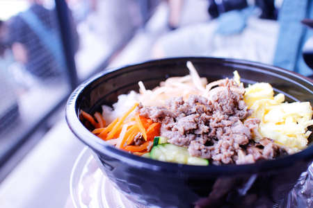 A spicy Korean meat bowl  at festival groundsの写真素材