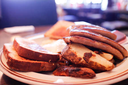 A hearty eggs sausage and toast breakfastの写真素材