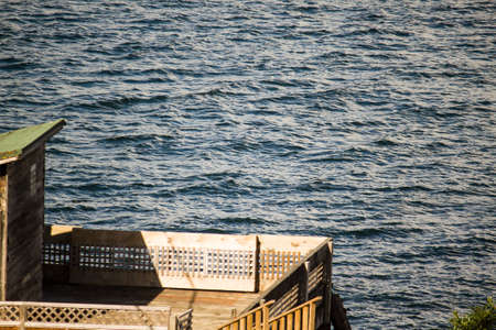 Small wooden patio by the seaの写真素材