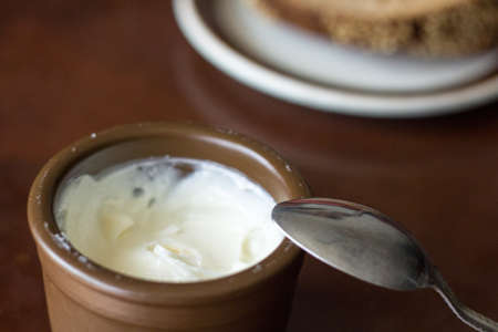 Allioli- homemade traditional Spanish garlic dip in earthenware jarの写真素材