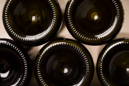 Wall of back-lit green bottles. glass background, glass texture. selective focus