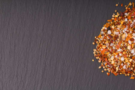 Different kind of spices on a black stone background. copy spaceの写真素材