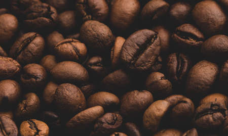 Roasted coffee beans background close up. Toned