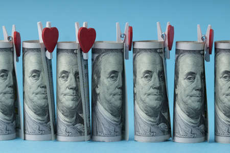line of rolled dollar bills with red heartsの写真素材