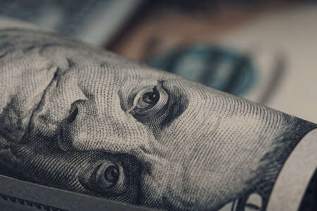 Extreme macro of 100 dollar bill with Benjamin Franklin portrait. United states hundred dollars money billの写真素材