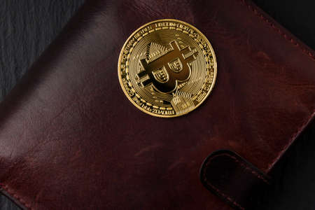 Metal bitcoin on brown leather wallet. Close upの写真素材