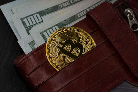Close-Up Of Gold Coin Bitcoin and Dollar Bills