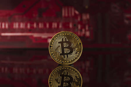 Bitcoin golden coin on computer circuit boardの写真素材