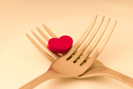 Romantic dinner. Golden forks with red heart. valentine dayの写真素材