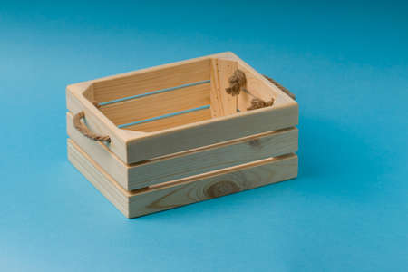 Wooden box on blue background. close upの写真素材