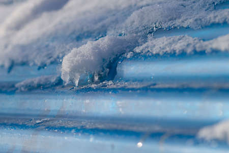 Blue roof covered with snow in winter season.