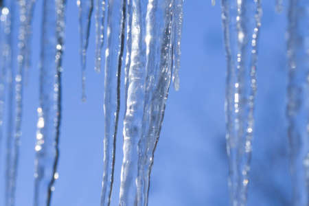 set of big icicles on sky backgroundの写真素材