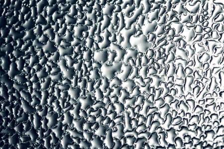 wet window glass with splashes and drops of waterの写真素材