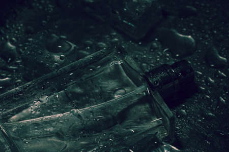 Bottle of perfume, ice cubes close up. Tonedの写真素材