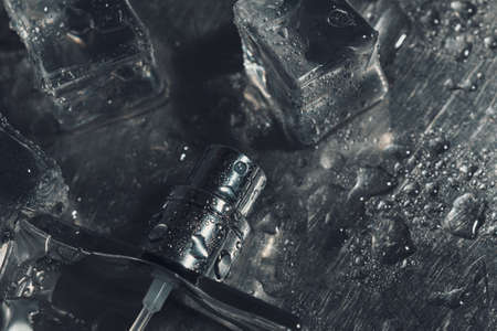 creative macro photo of perfume glass bottle and ice cubes.の写真素材