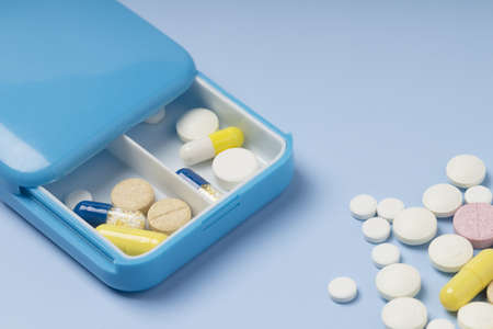 Daily dosage of medication in blue pill dispenser.の写真素材