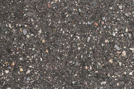wet asphalt road texture, dark background. Background of wet and dark gray asphaltの写真素材