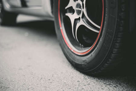 Car wheels close up on a background of asphalt. Car tires. Rear-side view of carの写真素材