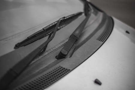 Dirty car window with a wiper bladeの写真素材