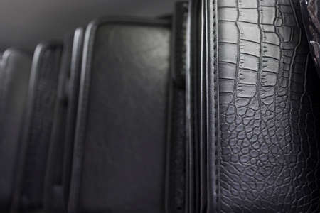Different black leather suit and clutch backgroundの写真素材