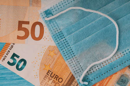 Face mask on Euro banknotes bill . coronavirus (Covid-19) and EU financial crisis conceptの写真素材