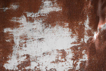 old iron plate covered with rust with white colored paint . Rusty metal surface texture background