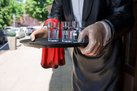 statue of awaiter at the entrance of a restaurant . Restaurant and cafe conceptの写真素材