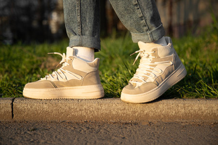 Stylish woman with shoes and rolled up jeans. close up view