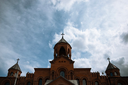 Armenian Christian church against blue cloudy sky. Russia , Vladikavkazの写真素材