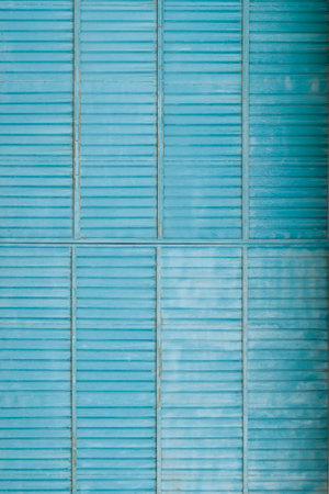 Ribbed meatl door texture background. Old blue gate as background. Copy space
