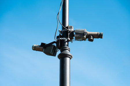 Close-up of two 60 GHz wireless network transmitters or small cells mounted on a black lamp post.の写真素材