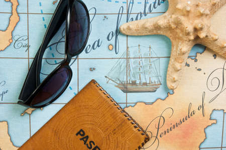 Still life with things leisure and travel on a background of map