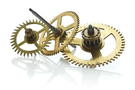 gears from old clock isolated on white background with reflectionの写真素材
