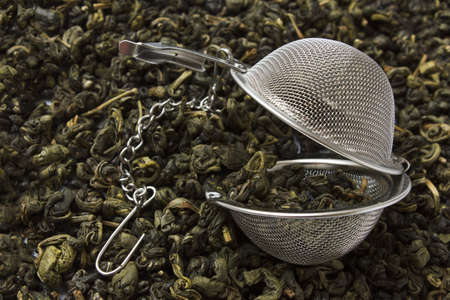 strainer against the background spilled green teaの写真素材