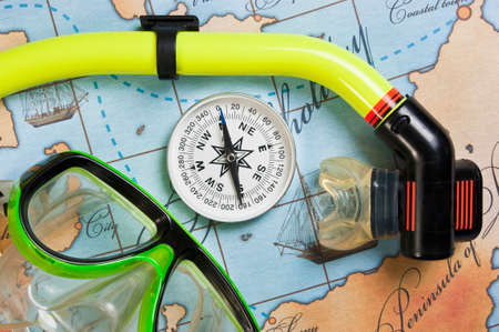 swimming accessories and items for leisure travel on a background map