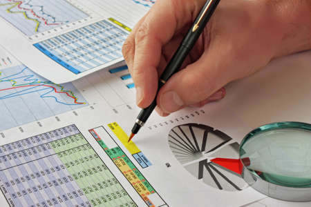 Graphs tables and documents laid on the table