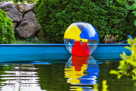 Colorful children's ball floating in the poolの写真素材