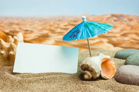 Umbrella on the sand on the background of the beachの写真素材
