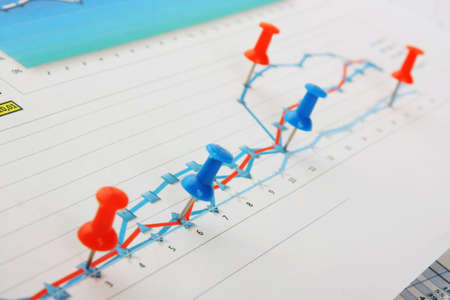 Graphs tables and documents laid on the table