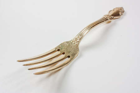 Golden fork isolated on white background