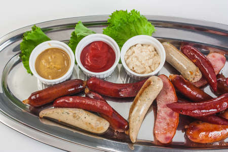 Bavarian sausages with ketchup isolated on a white backgroundの写真素材