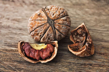 Walnuts in paper bags on the background of an old wooden board